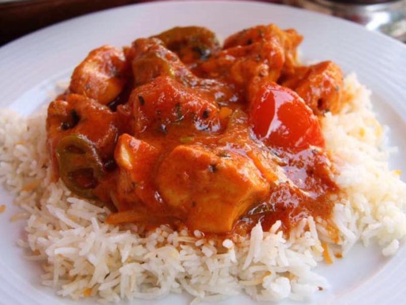 Curry with peppers and tomato served over basmati rice